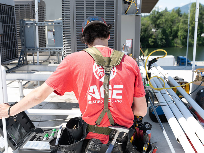 Age technician installing an air conditioner