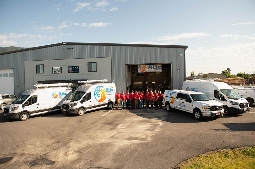 Age team standing in front of their shop with their fleet of vehicles Age team standing in front of their shop with their fleet of vehicles